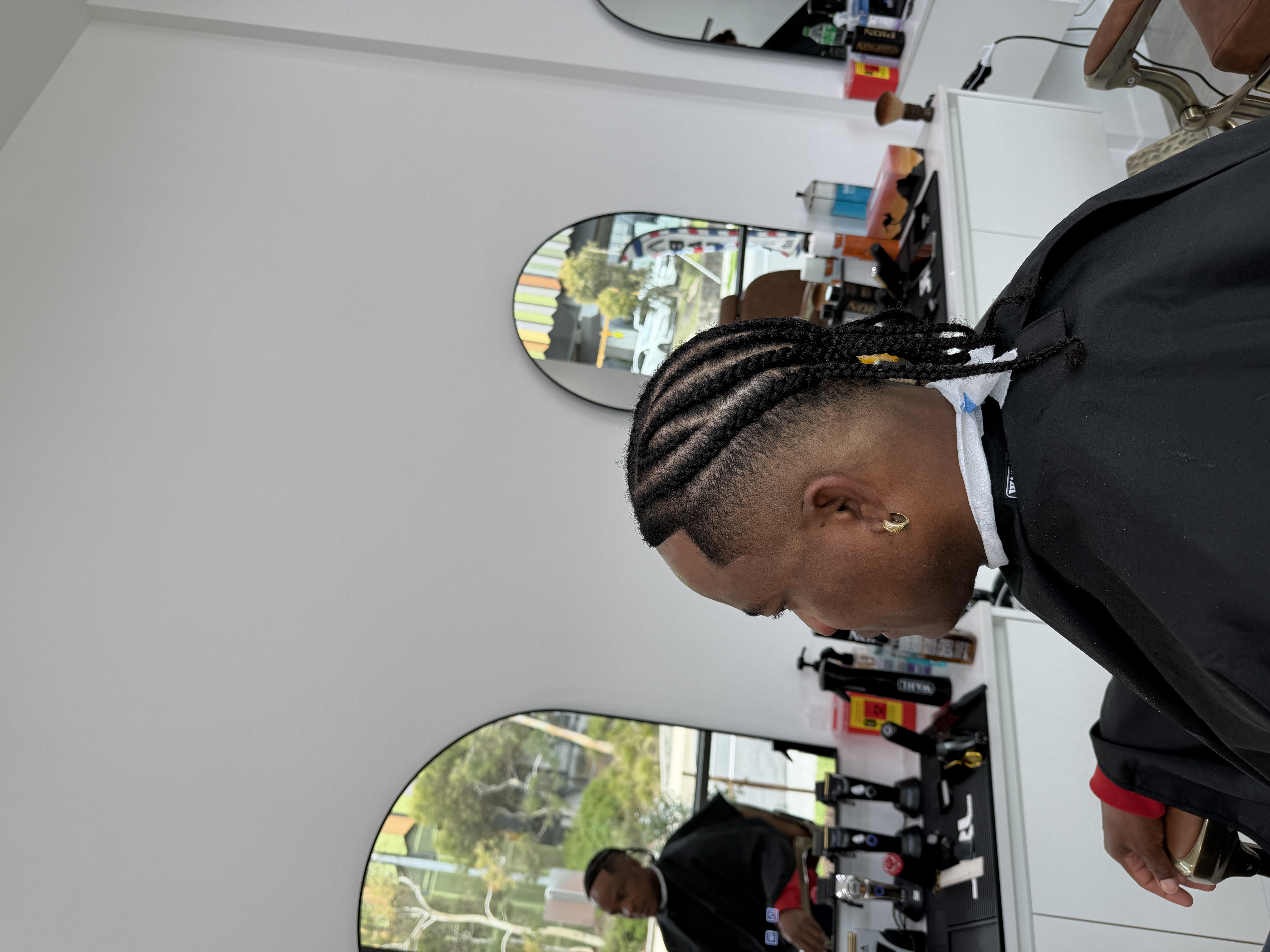 Cornrow braids paired with a clean temple fade and line-up