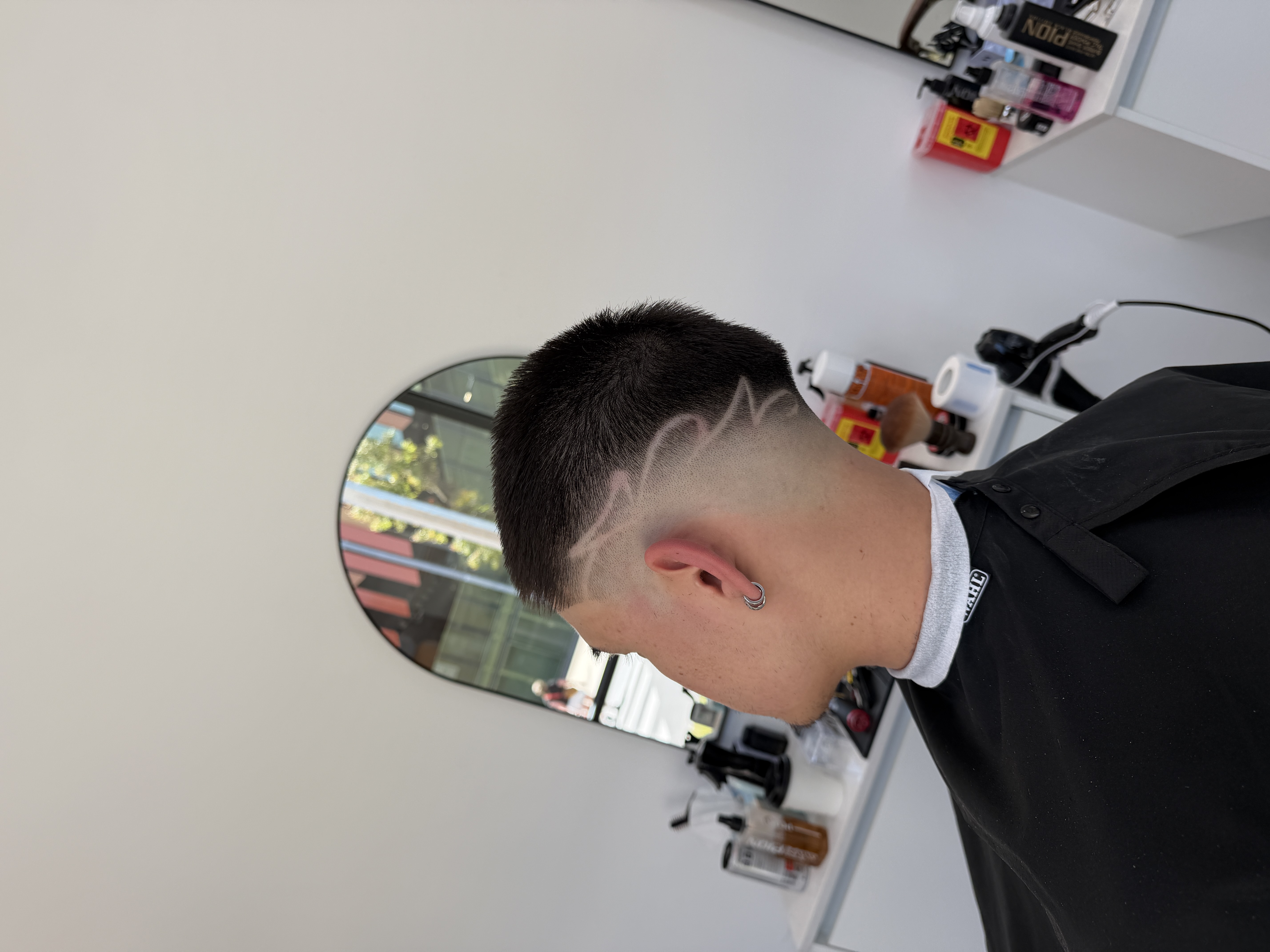 Neat low fade with longer textured hair on top